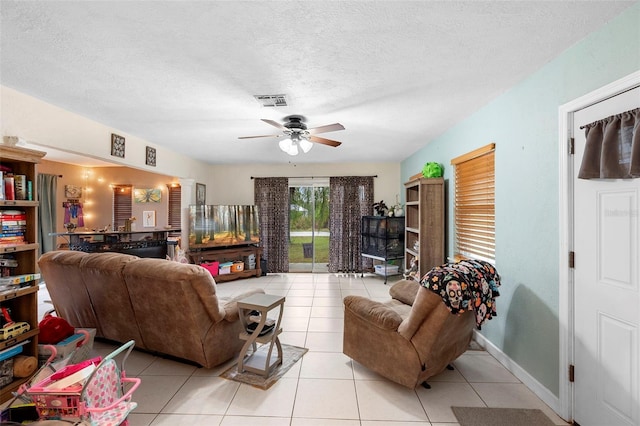 303 Thrush Ave, Sebring, FL 33870 - living area featuring a ceiling fan, light tile patterned flooring, a textured ceiling, and baseboards