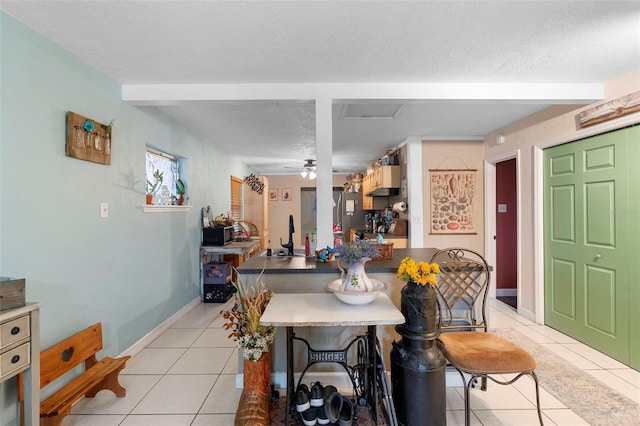 303 Thrush Ave, Sebring, FL 33870 - dining area featuring light tile patterned floors, a textured ceiling, and baseboards