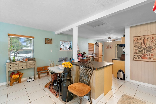 303 Thrush Ave, Sebring, FL 33870 - kitchen with light tile patterned floors, dark countertops, and baseboards