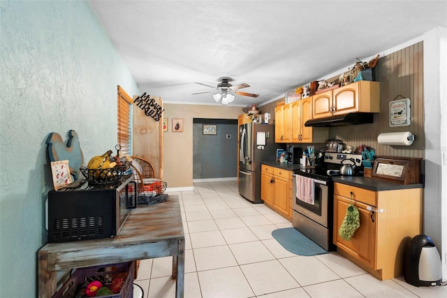 303 Thrush Ave, Sebring, FL 33870 - kitchen featuring appliances with stainless steel finishes, under cabinet range hood, dark countertops, a ceiling fan, and light tile patterned flooring