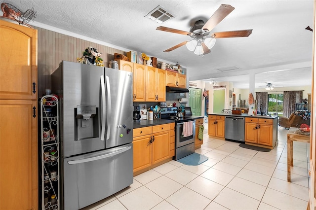 303 Thrush Ave, Sebring, FL 33870 - kitchen with appliances with stainless steel finishes, ceiling fan, dark countertops, under cabinet range hood, and light tile patterned floors
