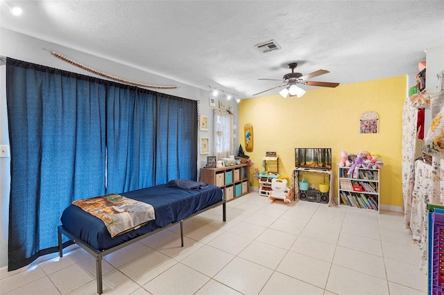 303 Thrush Ave, Sebring, FL 33870 - living area with a ceiling fan, a textured ceiling, and tile patterned floors