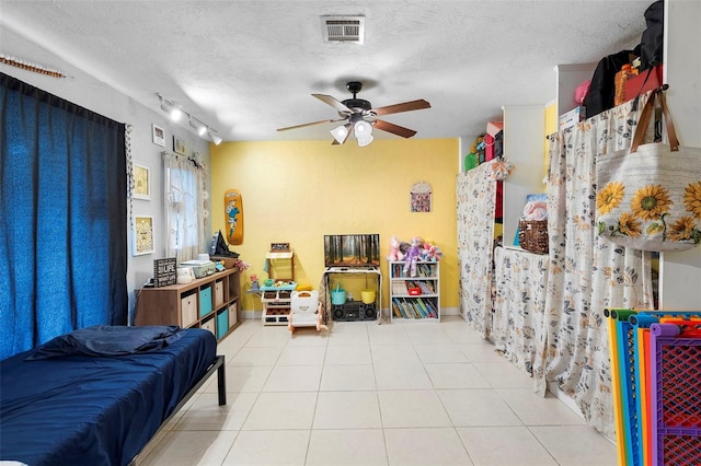 303 Thrush Ave, Sebring, FL 33870 - tiled bedroom with a textured ceiling, baseboards, and ceiling fan