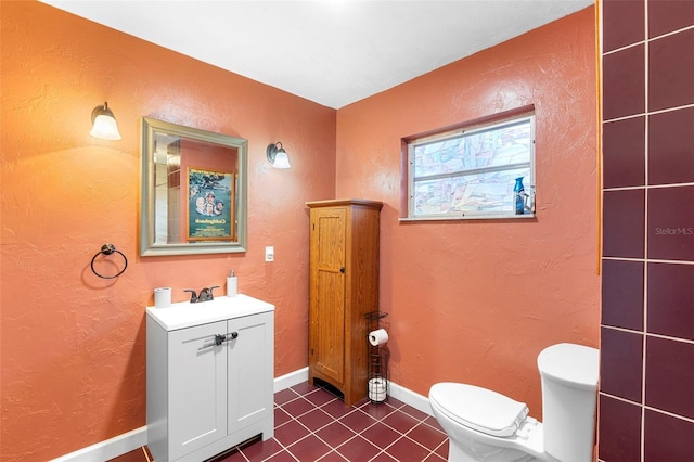 303 Thrush Ave, Sebring, FL 33870 - bathroom featuring tile patterned flooring, toilet, vanity, a textured wall, and baseboards