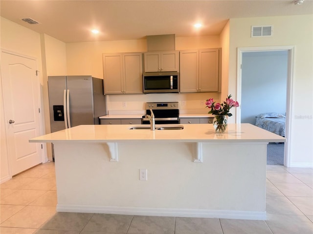 2569 Trinidad Rd, Haines City, FL 33844 - kitchen with stainless steel appliances, a sink, a kitchen bar, and light countertops
