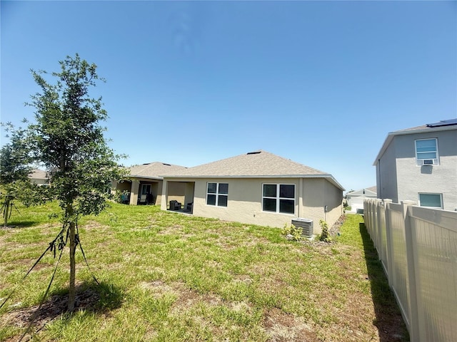 2569 Trinidad Rd, Haines City, FL 33844 - back of property featuring central AC unit and stucco siding