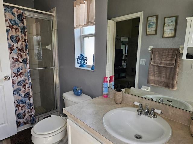 bathroom with tiled shower, toilet, and vanity