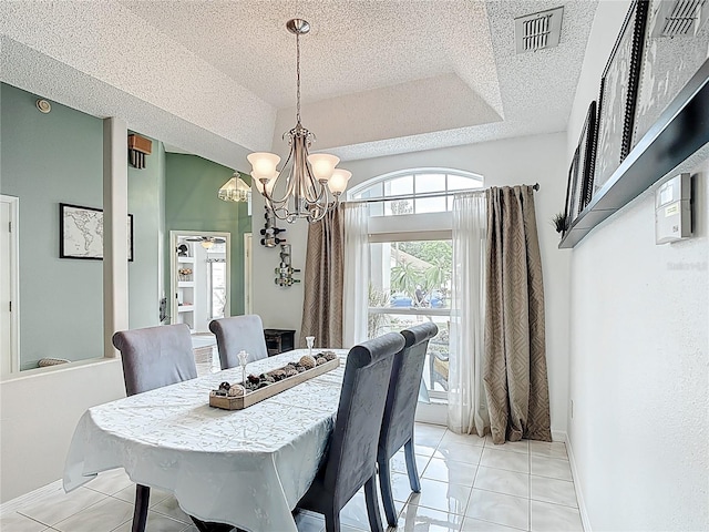 12445 Bohannon Blvd, Orlando, FL 32824 - dining area with a chandelier, a textured ceiling, light tile patterned floors, and baseboards