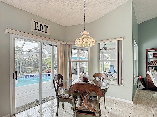 12445 Bohannon Blvd, Orlando, FL 32824 - dining room featuring a textured ceiling, baseboards, and lofted ceiling