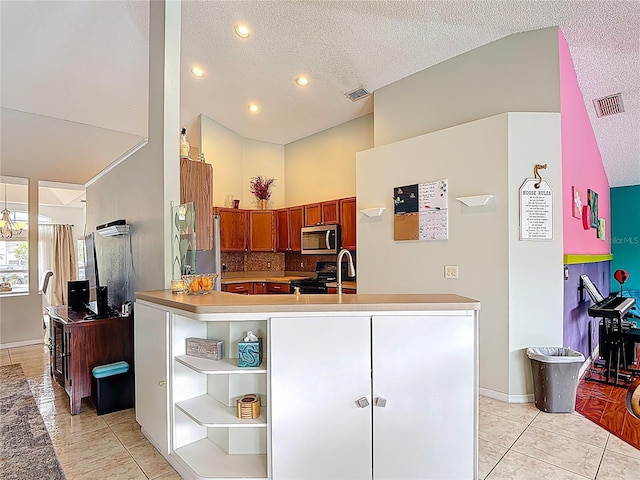 12445 Bohannon Blvd, Orlando, FL 32824 - kitchen with stainless steel microwave, black range, a sink, high vaulted ceiling, and baseboards
