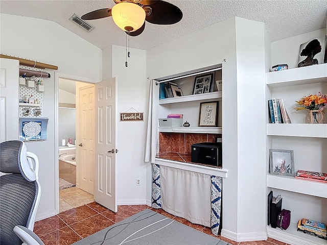 12445 Bohannon Blvd, Orlando, FL 32824 - bedroom with a textured ceiling, lofted ceiling, tile patterned flooring, a ceiling fan, and ensuite bath