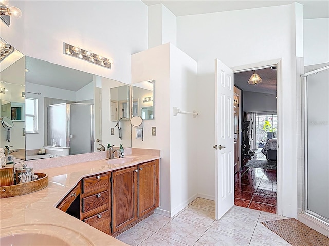12445 Bohannon Blvd, Orlando, FL 32824 - ensuite bathroom with a shower stall, double vanity, baseboards, marble finish flooring, and a towering ceiling