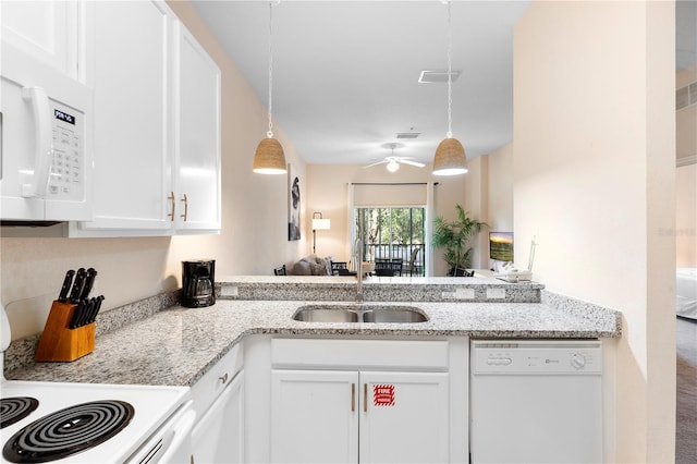 kitchen with white appliances, a sink, white cabinets, a ceiling fan, and hanging light fixtures