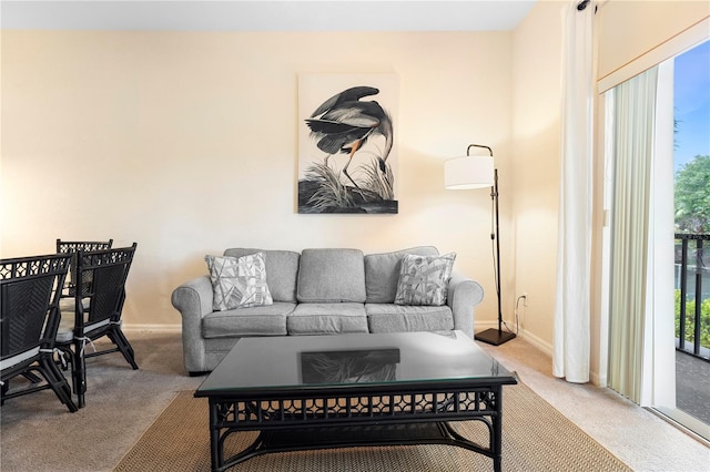 carpeted living room with baseboards