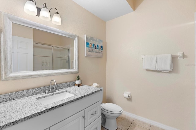 full bath featuring a stall shower, tile patterned flooring, toilet, vanity, and baseboards