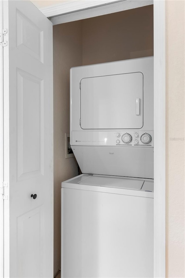 laundry room with stacked washer / drying machine