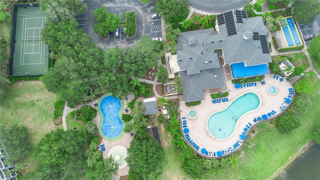 aerial view of property and surrounding area with a pool area