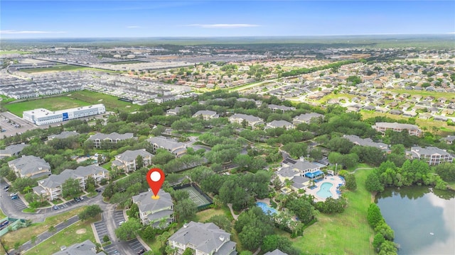 aerial view of property's location featuring a pool area and a large body of water