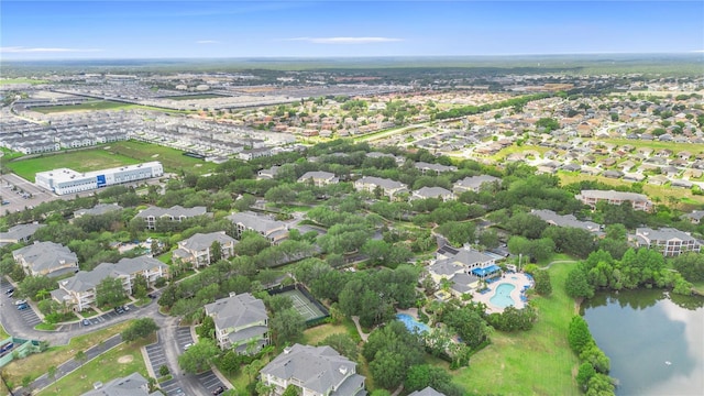 aerial view of property and surrounding area with a pool and a nearby body of water