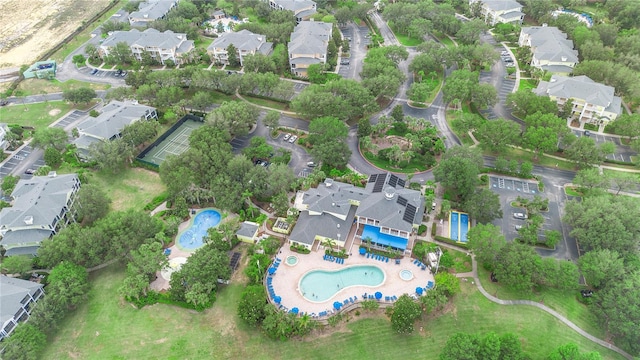 aerial overview of property's location with a pool area and nearby suburban area