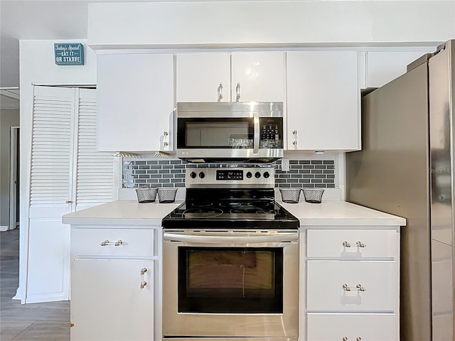 320 S Seminole Ave, Lake Alfred, FL 33850 - kitchen featuring stainless steel appliances, light countertops, and white cabinetry