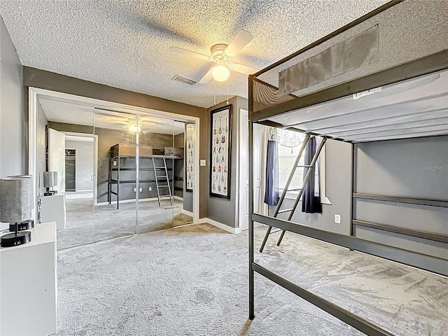 320 S Seminole Ave, Lake Alfred, FL 33850 - unfurnished bedroom with carpet flooring, a closet, ceiling fan, and a textured ceiling