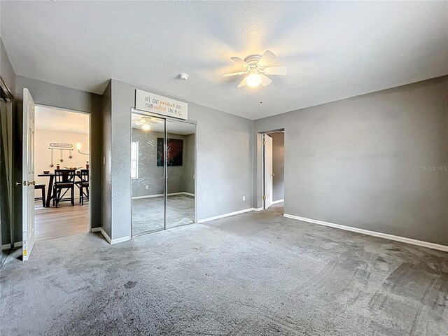 320 S Seminole Ave, Lake Alfred, FL 33850 - unfurnished bedroom with carpet, a closet, baseboards, and ceiling fan