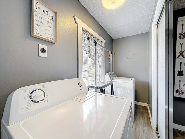 320 S Seminole Ave, Lake Alfred, FL 33850 - laundry area featuring independent washer and dryer, a textured ceiling, wood finished floors, and baseboards