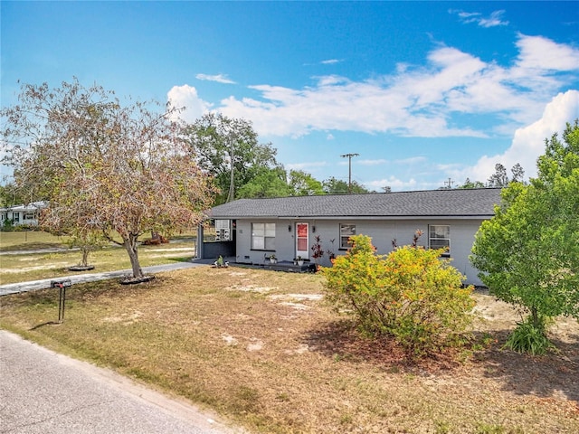 320 S Seminole Ave, Lake Alfred, FL 33850 - view of front of property featuring a front yard, driveway, and an attached carport