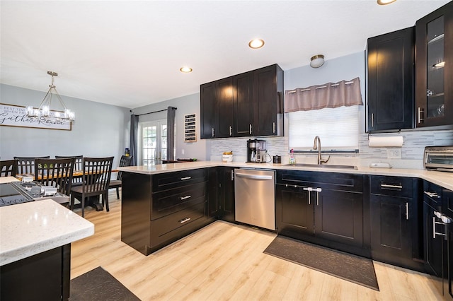 1730 Carolyn Ct, Saint Cloud, FL 34769 - kitchen featuring dishwasher, a sink, a peninsula, light wood-style flooring, and recessed lighting