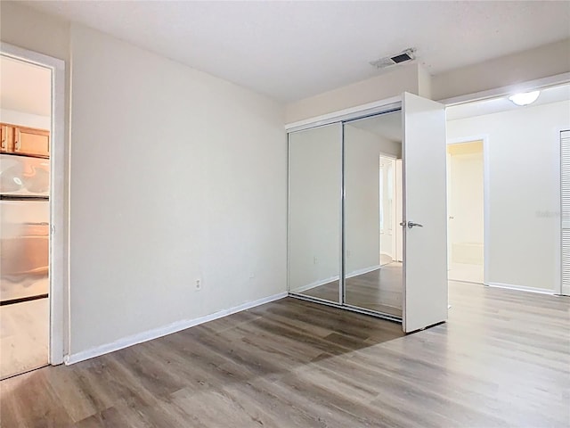 7865 Sugar View Ct Unit 7865, Orlando, FL 32819 - unfurnished bedroom featuring wood finished floors, a closet, and baseboards