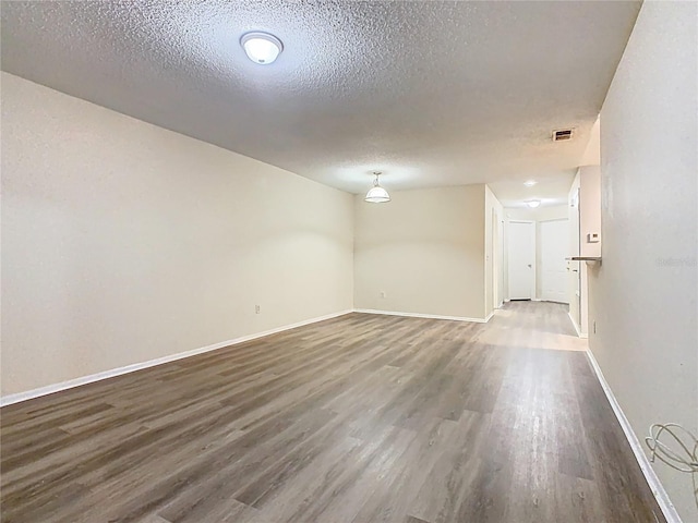 7865 Sugar View Ct Unit 7865, Orlando, FL 32819 - spare room featuring wood finished floors, a textured ceiling, and baseboards