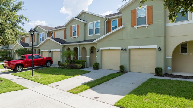 3181 Tocoa Cir, Kissimmee, FL 34746 - view of property featuring a garage, stucco siding, a front yard, and driveway