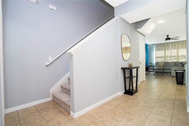 3181 Tocoa Cir, Kissimmee, FL 34746 - stairway featuring a ceiling fan, tile patterned floors, and baseboards