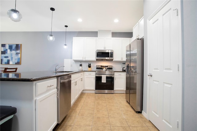 3181 Tocoa Cir, Kissimmee, FL 34746 - kitchen with appliances with stainless steel finishes, a peninsula, a sink, white cabinetry, and recessed lighting