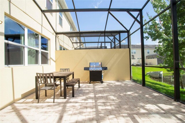 3181 Tocoa Cir, Kissimmee, FL 34746 - view of patio / terrace featuring glass enclosure, outdoor dining area, and a grill