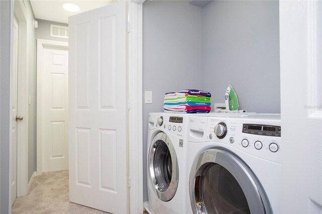 3181 Tocoa Cir, Kissimmee, FL 34746 - clothes washing area with washing machine and clothes dryer and light carpet