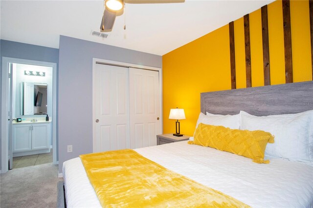 3181 Tocoa Cir, Kissimmee, FL 34746 - carpeted bedroom with a closet, connected bathroom, and ceiling fan