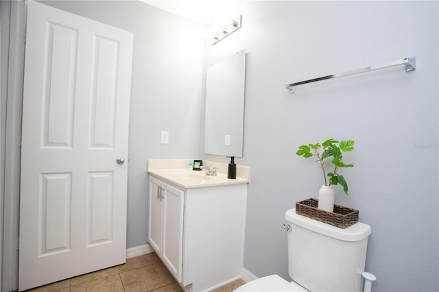3181 Tocoa Cir, Kissimmee, FL 34746 - bathroom featuring vanity, toilet, tile patterned flooring, and baseboards