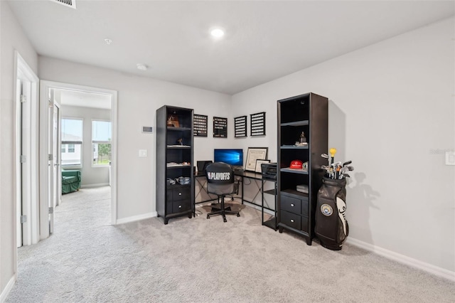 carpeted home office featuring baseboards