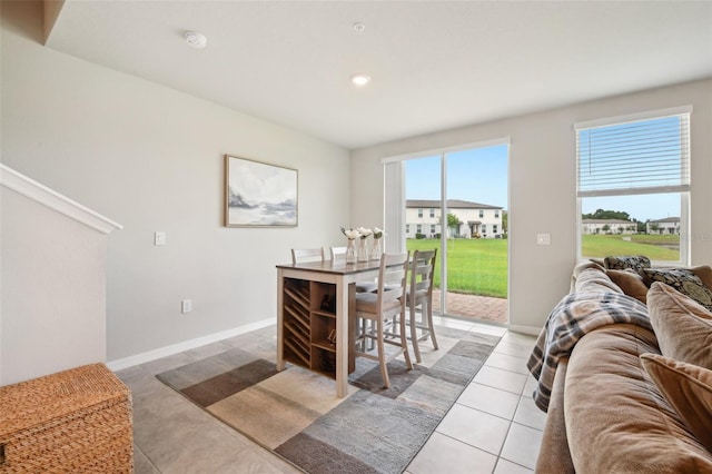 dining area with light tile patterned floors, baseboards, and recessed lighting