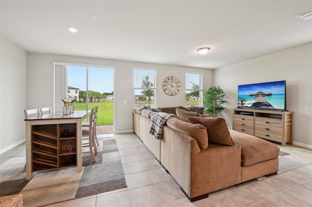 living room featuring light tile patterned floors and baseboards