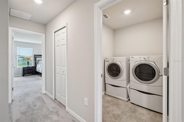 laundry room featuring washer and dryer, baseboards, and recessed lighting