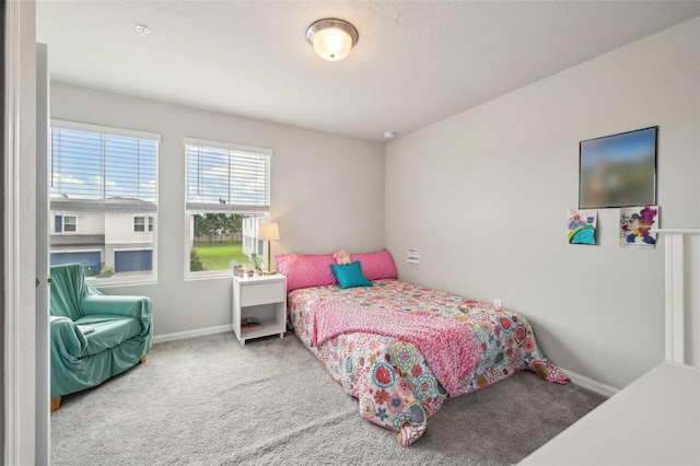 bedroom featuring carpet flooring and baseboards