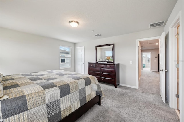 bedroom with attic access, carpet floors, a closet, and baseboards