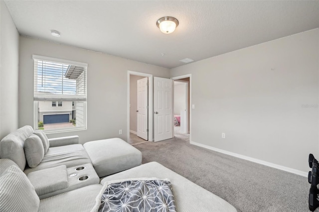 living room featuring carpet and baseboards