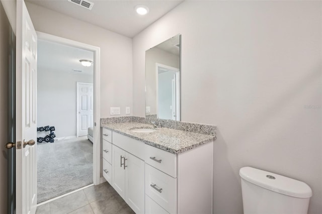 bathroom featuring vanity, toilet, and tile patterned floors
