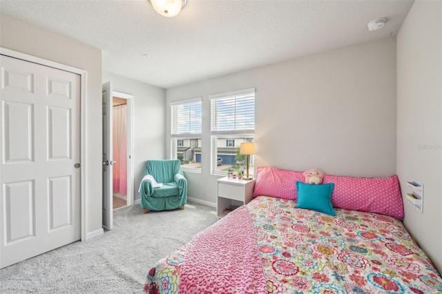 carpeted bedroom with baseboards