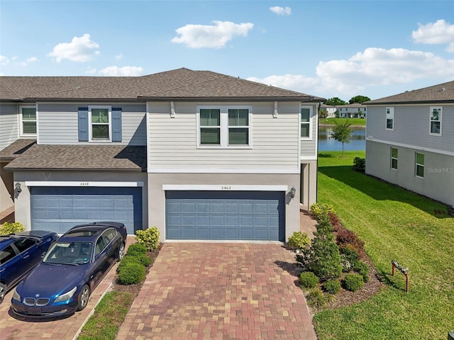 2462 Sweet Viburnum Way, Ocoee, FL 34761 - view of front of property featuring an attached garage, decorative driveway, a front yard, and a water view