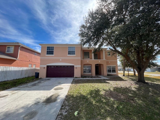 340 Cimarron Ct, Poinciana, FL 34759 - view of front of home featuring fence, stucco siding, an attached garage, and concrete driveway
